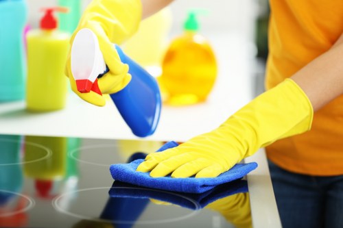 Trained Merton carpet cleaner using protective gloves during service